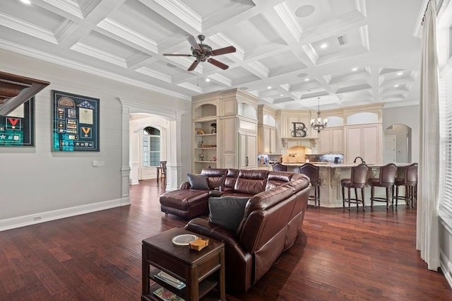 living area featuring arched walkways, dark wood-style floors, and beam ceiling