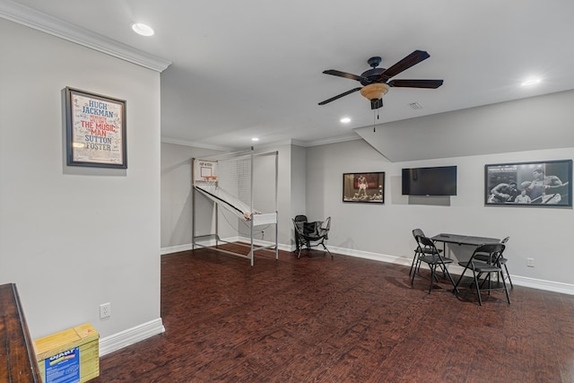 interior space featuring a ceiling fan, crown molding, wood finished floors, and baseboards