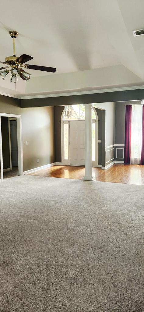 301 Roslyn Glen Way, Dothan, AL 36305 - unfurnished living room with light carpet, decorative columns, and a ceiling fan