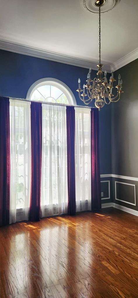 301 Roslyn Glen Way, Dothan, AL 36305 - spare room with a chandelier, ornamental molding, hardwood / wood-style floors, and wainscoting