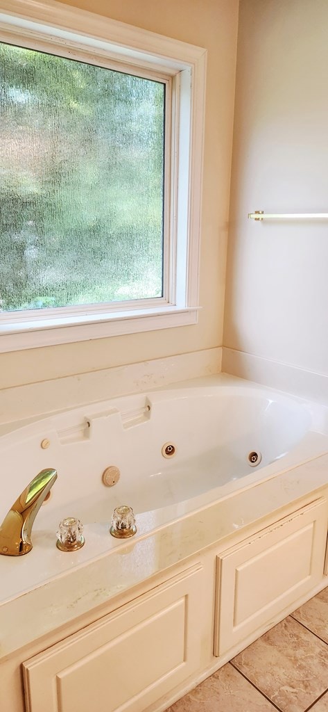 301 Roslyn Glen Way, Dothan, AL 36305 - bathroom with a tub with jets and tile patterned flooring