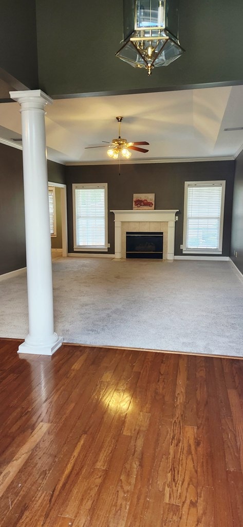 301 Roslyn Glen Way, Dothan, AL 36305 - unfurnished living room with decorative columns, a fireplace, a ceiling fan, and wood finished floors