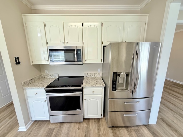 kitchen featuring light wood-type flooring, ornamental molding, appliances with stainless steel finishes, and baseboards