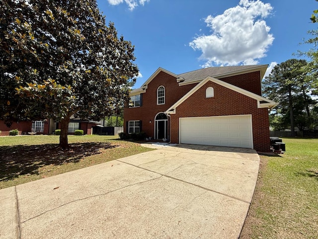 view of front facade featuring driveway, brick siding, fence, a garage, and a front yard