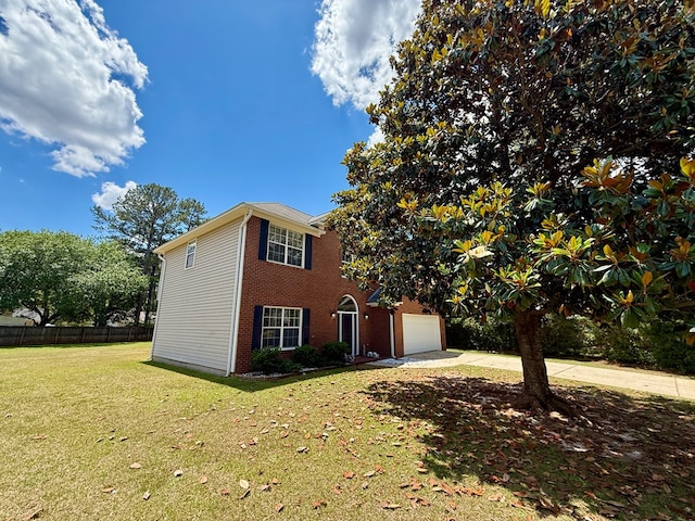view of front of home with fence, a front yard, brick siding, and concrete driveway