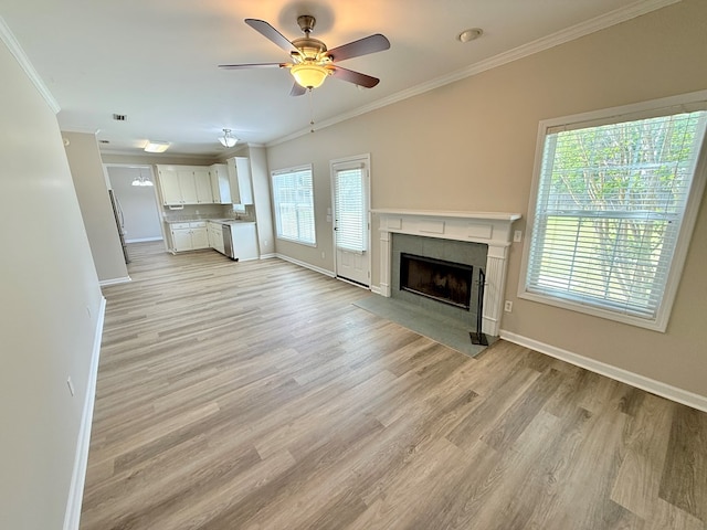 unfurnished living room with crown molding, baseboards, and a tile fireplace