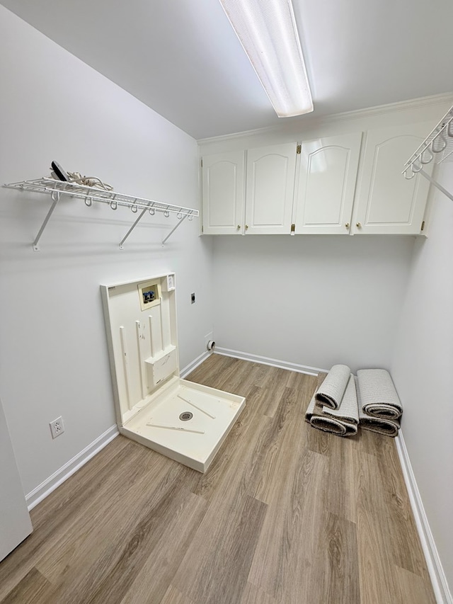 laundry room with light wood-style flooring, baseboards, washer hookup, hookup for an electric dryer, and cabinet space