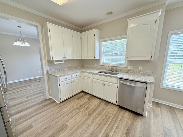 kitchen with light wood-style floors, appliances with stainless steel finishes, plenty of natural light, and a sink