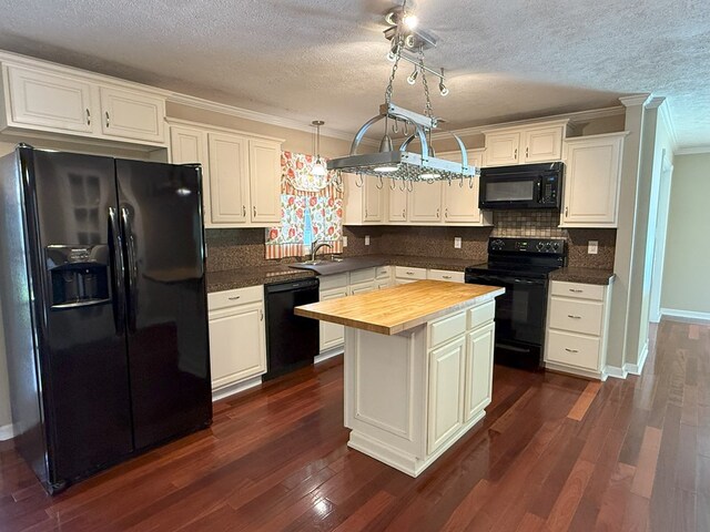 26 Goff St, Daleville, AL 36322 - kitchen featuring black appliances, wooden counters, crown molding, a textured ceiling, and dark wood-style floors