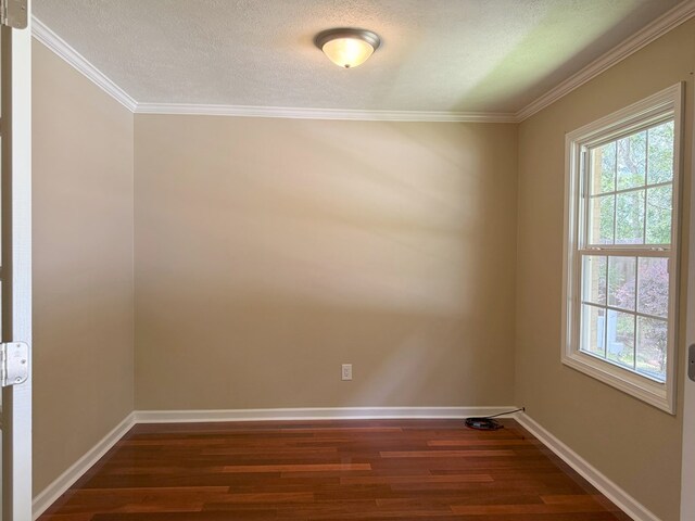 26 Goff St, Daleville, AL 36322 - empty room with dark wood-style floors, crown molding, and a textured ceiling
