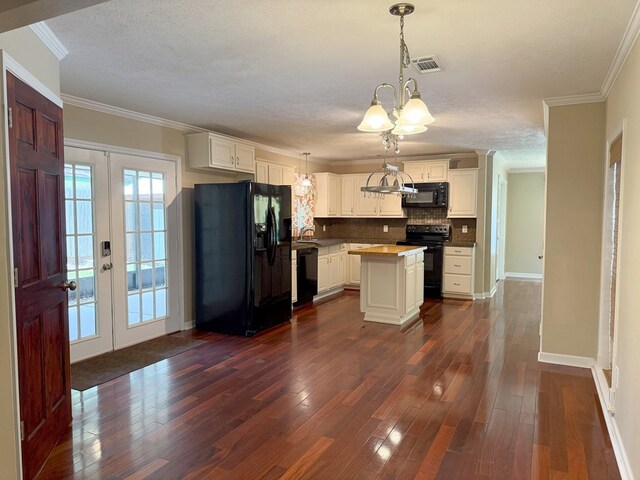 26 Goff St, Daleville, AL 36322 - kitchen with black appliances, decorative backsplash, dark wood-type flooring, french doors, and crown molding