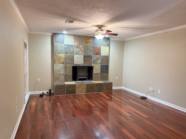 26 Goff St, Daleville, AL 36322 - unfurnished living room featuring a wood stove, wood finished floors, ceiling fan, ornamental molding, and a textured ceiling