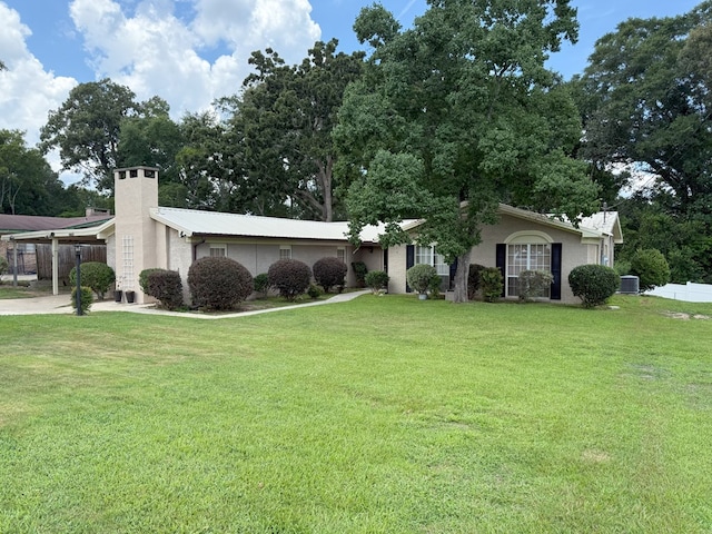 26 Goff St, Daleville, AL 36322 - view of front of house with a carport, a chimney, stucco siding, concrete driveway, and a metal roof
