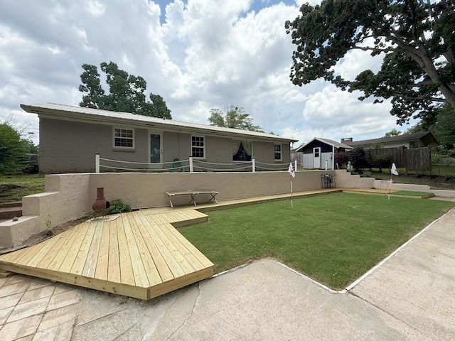 26 Goff St, Daleville, AL 36322 - rear view of property with a deck and an outbuilding
