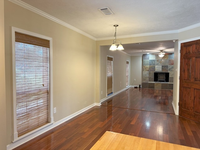 26 Goff St, Daleville, AL 36322 - unfurnished living room with wood-type flooring, a fireplace, crown molding, ceiling fan, and a chandelier