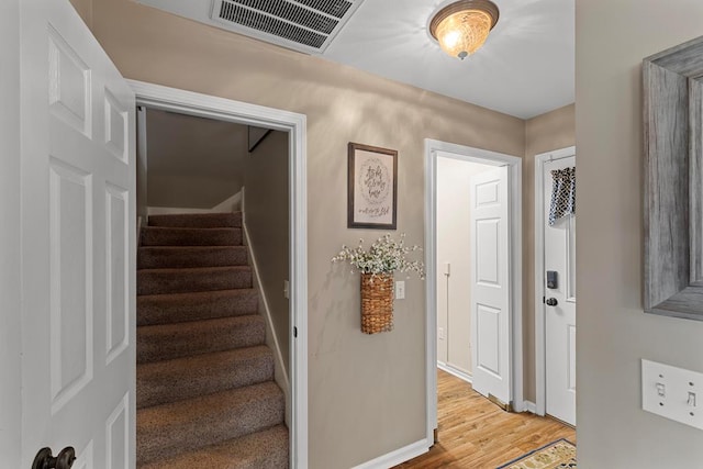 stairway featuring wood-type flooring