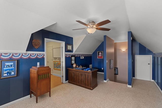 carpeted home office featuring ceiling fan and lofted ceiling