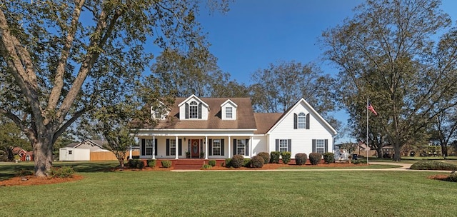 cape cod home with a porch and a front yard