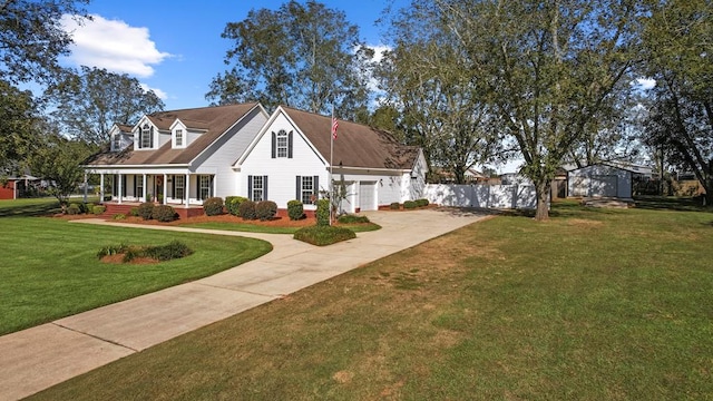 cape cod house featuring covered porch, a garage, and a front lawn