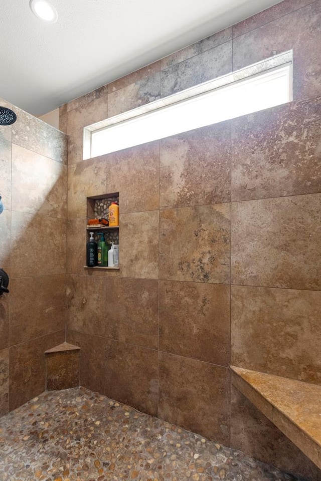 bathroom with a tile shower