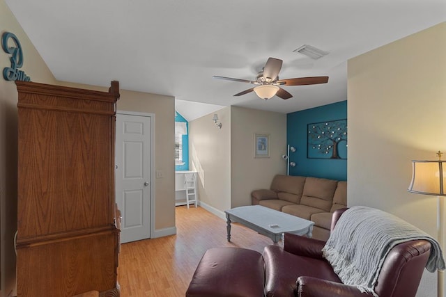 living room featuring light hardwood / wood-style floors and ceiling fan