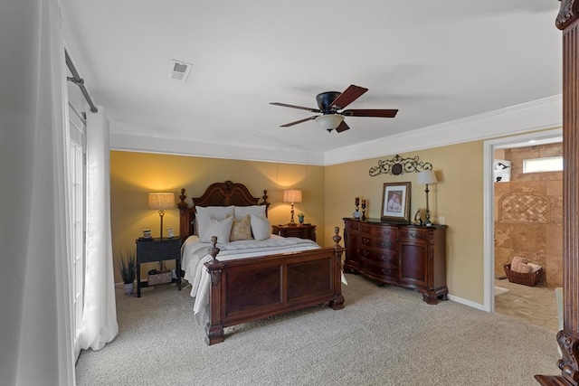 bedroom with ensuite bathroom, ceiling fan, light colored carpet, and ornamental molding