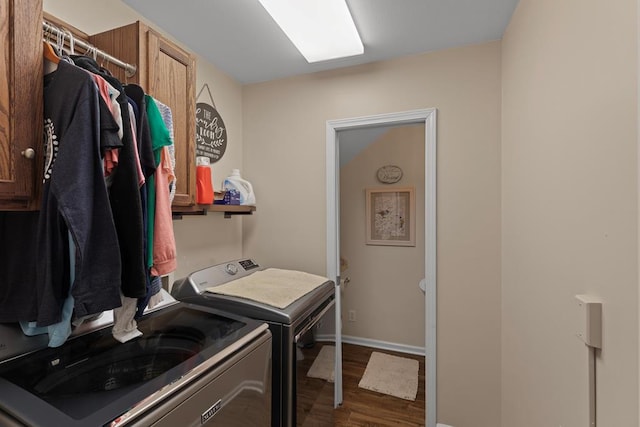 clothes washing area featuring separate washer and dryer and dark wood-type flooring