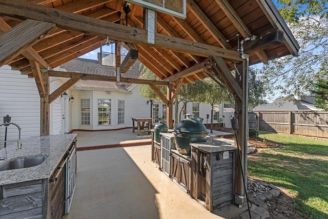 view of patio with a gazebo, area for grilling, sink, and an outdoor kitchen