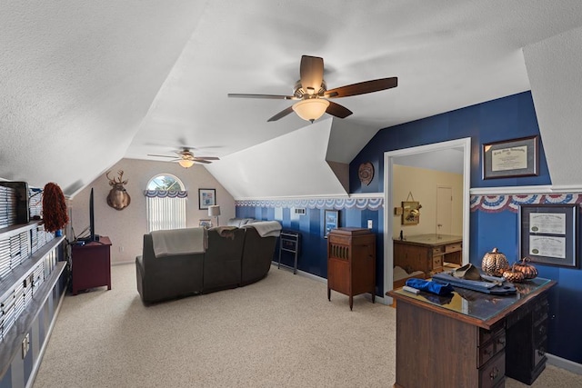 carpeted home office featuring a textured ceiling, ceiling fan, and lofted ceiling