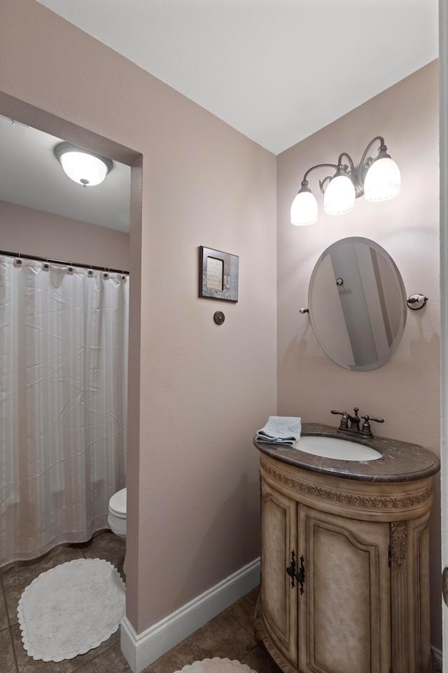 bathroom featuring tile patterned flooring, vanity, and toilet