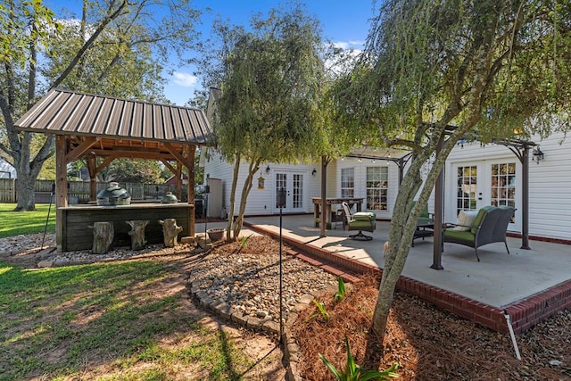 rear view of house featuring a gazebo, a patio area, and french doors