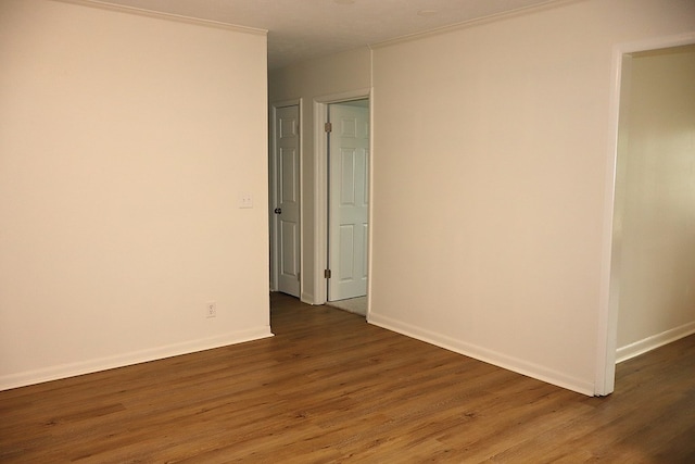unfurnished room featuring wood finished floors and baseboards