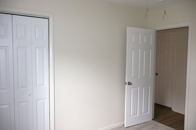 unfurnished bedroom featuring a closet and baseboards