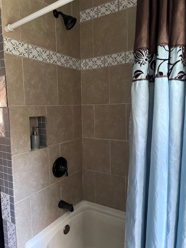 bathroom featuring shower / bathtub combination with curtain