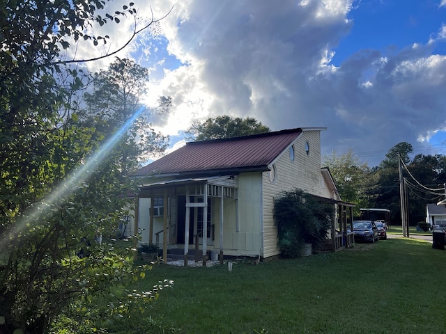 back of property featuring a yard