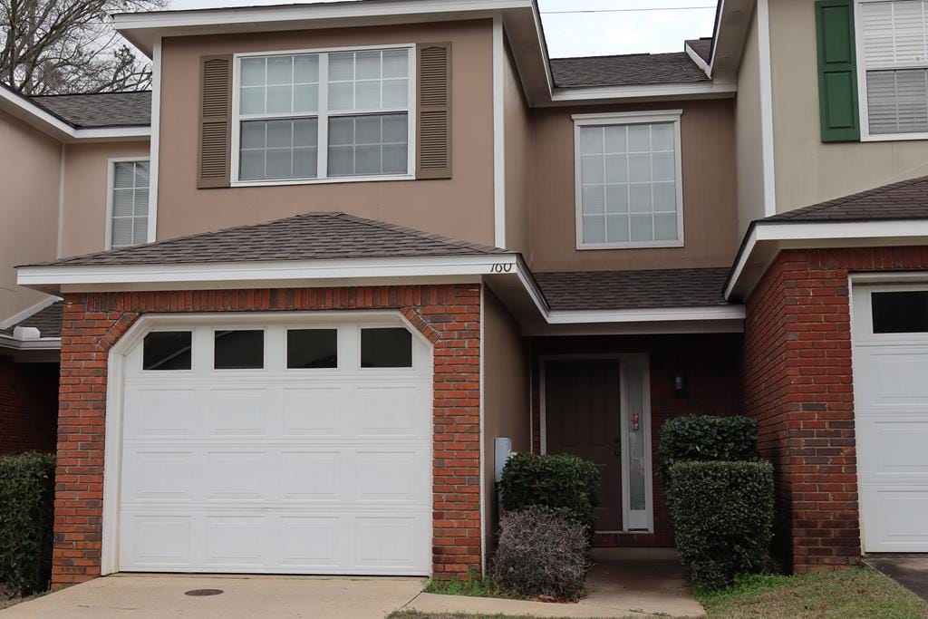 townhome / multi-family property featuring a garage