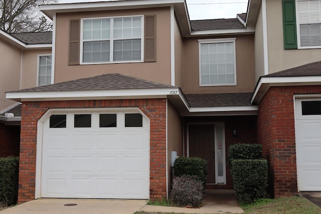 townhome / multi-family property featuring a garage