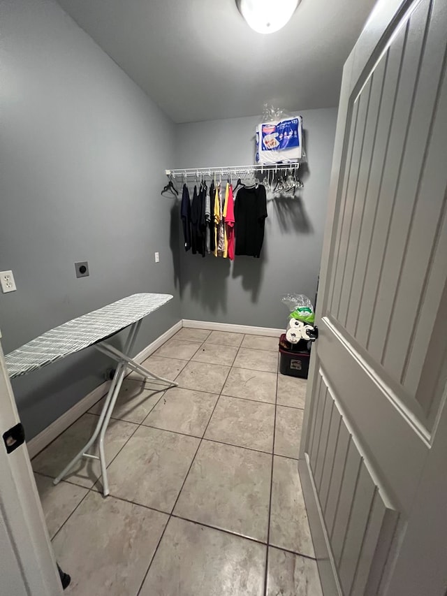 washroom featuring hookup for an electric dryer and light tile patterned flooring