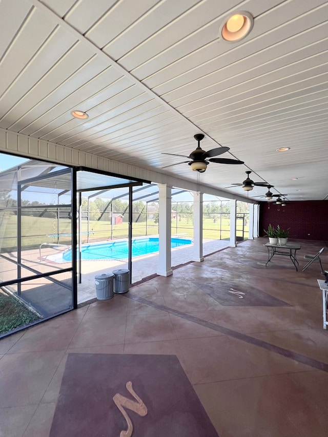 exterior space with ceiling fan, a healthy amount of sunlight, and a pool