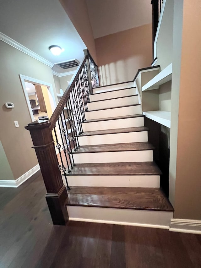 stairs featuring hardwood / wood-style flooring and ornamental molding