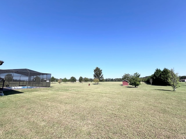 view of yard with a rural view and a lanai