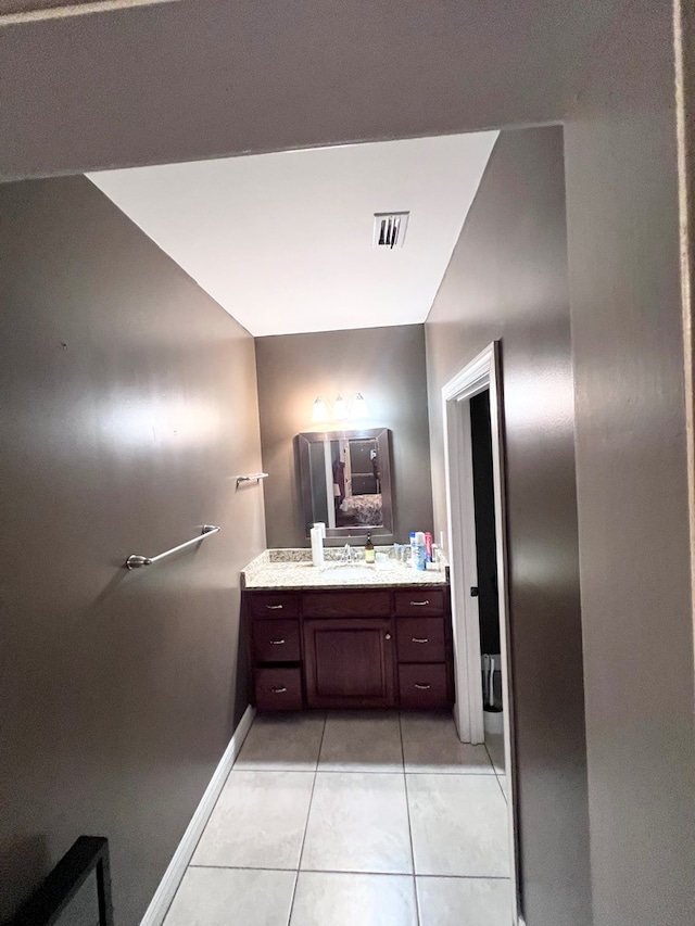 bathroom featuring tile patterned flooring and vanity