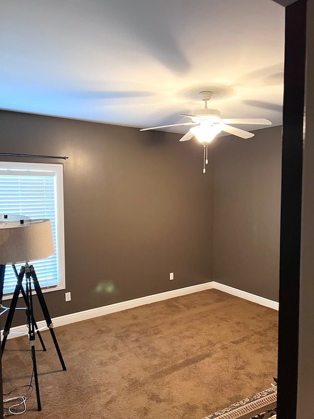 unfurnished room with carpet and ceiling fan