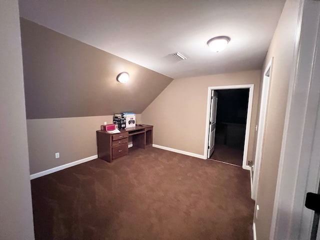 bonus room featuring vaulted ceiling and dark colored carpet