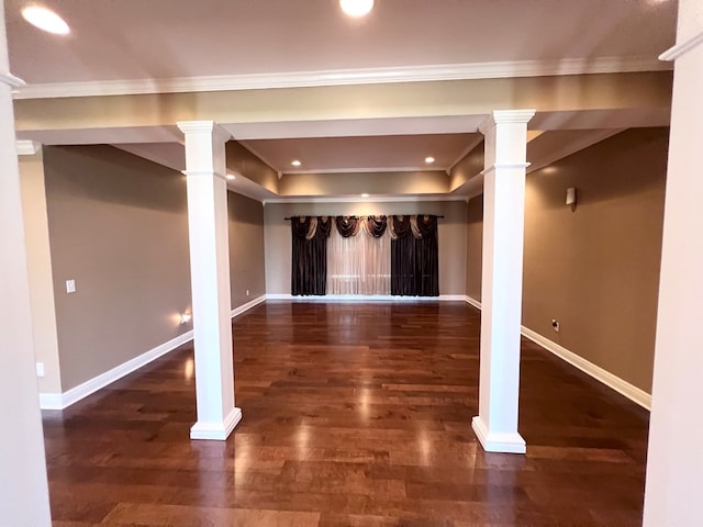 basement featuring dark hardwood / wood-style flooring and crown molding