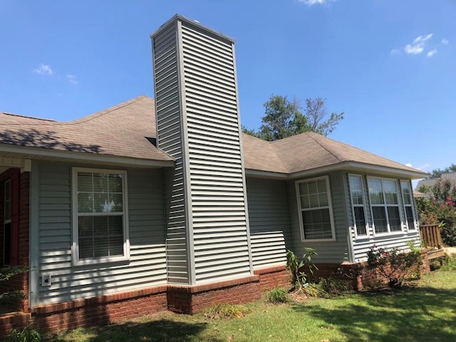 view of property exterior featuring a lawn