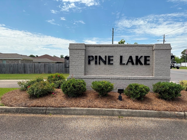 community sign featuring fence