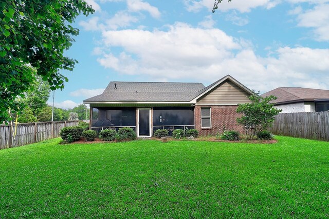 rear view of house with a sunroom and brick siding
