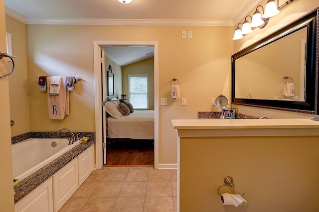 ensuite bathroom with ornamental molding, a garden tub, tile patterned flooring, vanity, and baseboards