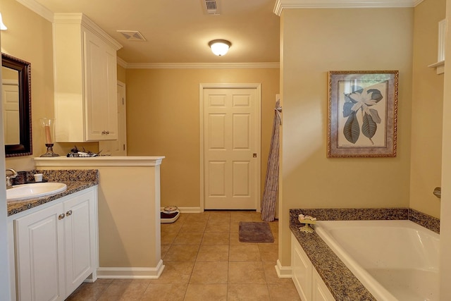 full bath featuring a garden tub, vanity, tile patterned flooring, baseboards, and crown molding